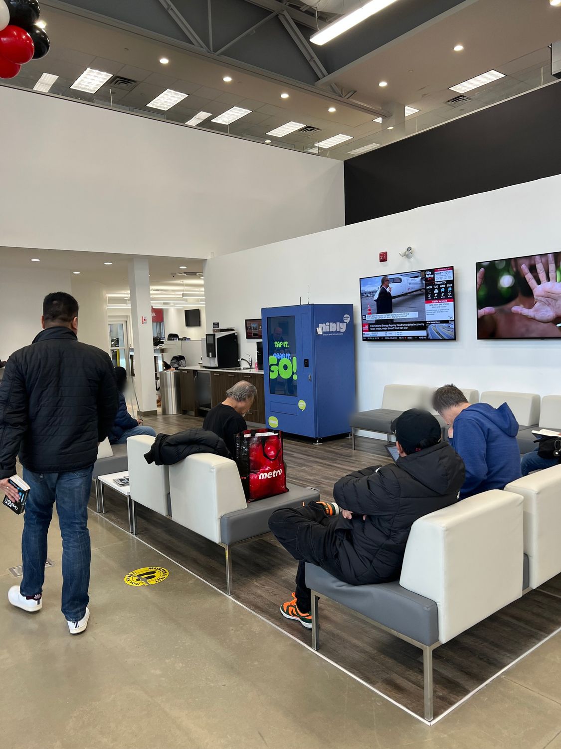 Customers beside the Conte Vending machine